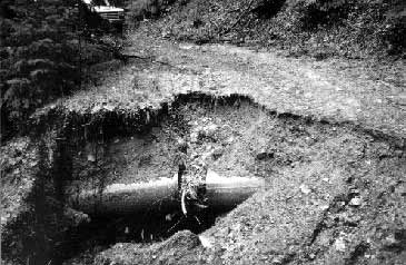 big washout and exposed, broken culvert